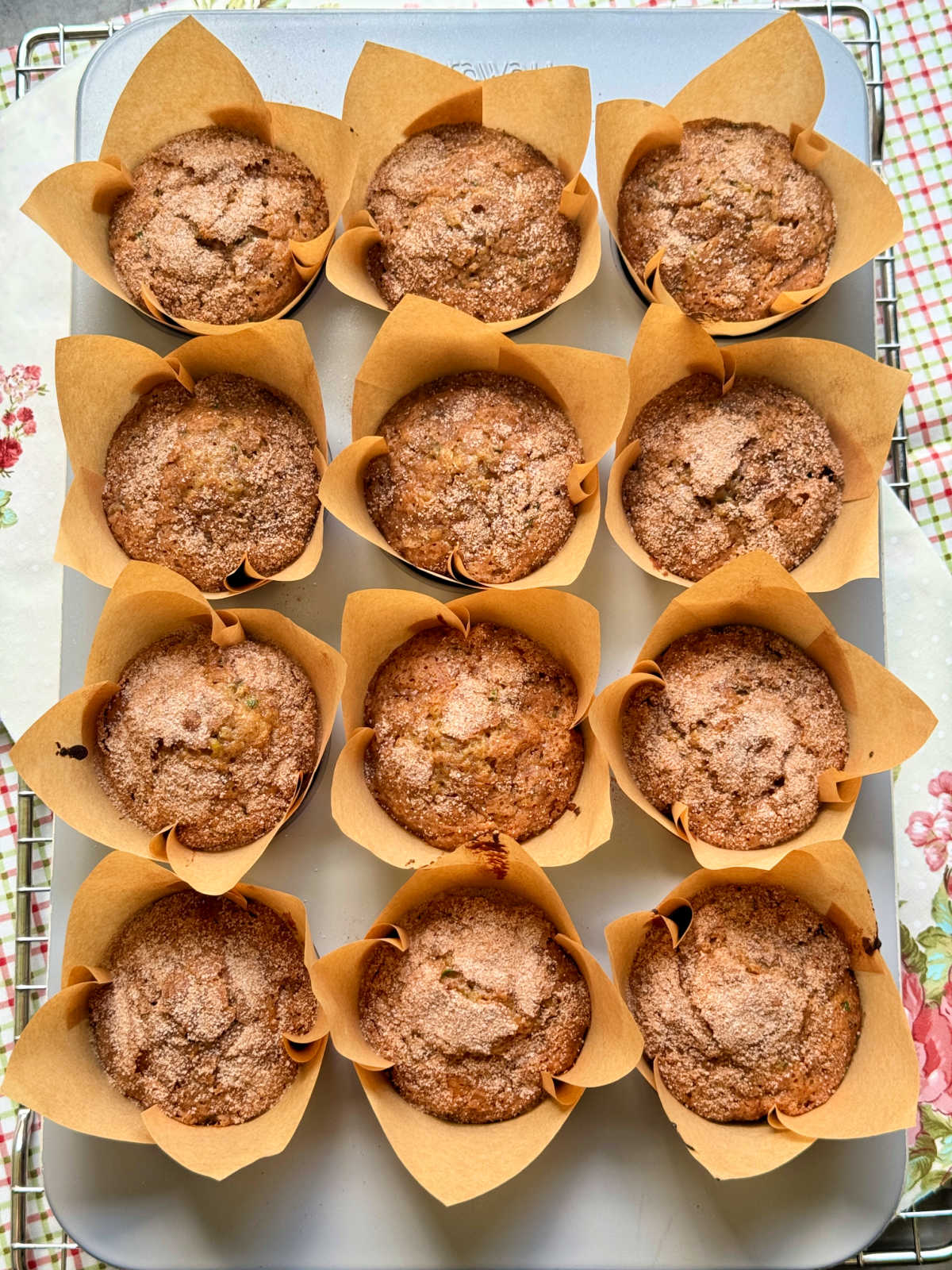 a muffin tin full of freshly baked zucchini muffins