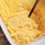 a serving of parmesan polenta ready to be spooned from the serving dish