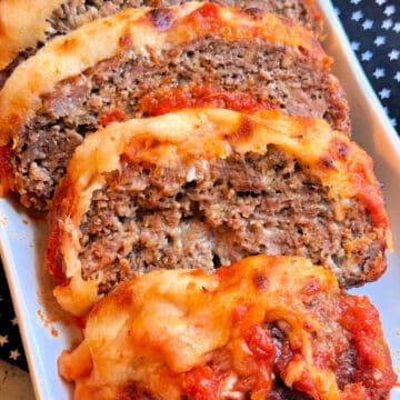 plated and sliced Italian meatloaf smothered with sauce and cheese