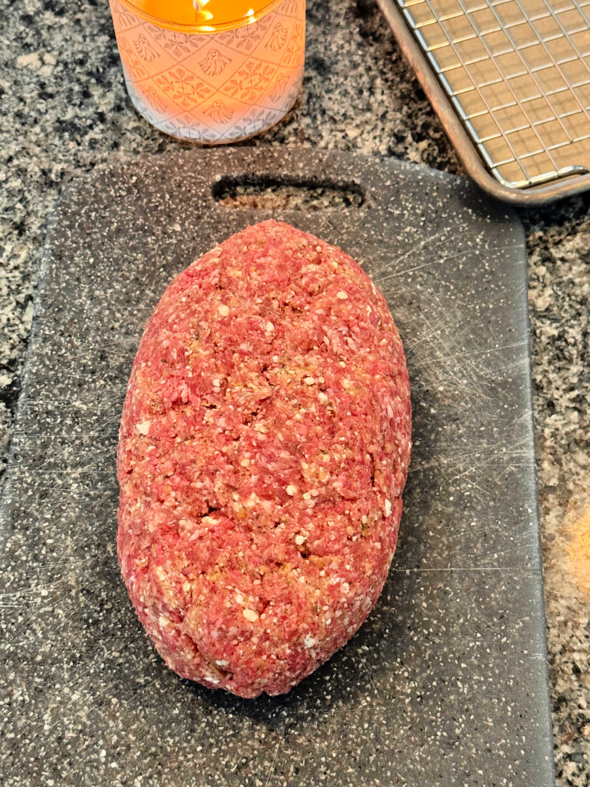 a formed meatloaf on a cutting board, ready to be baked