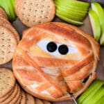 baked wheel of mummy brie with black olive eyes