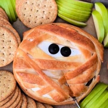 baked wheel of mummy brie with black olive eyes