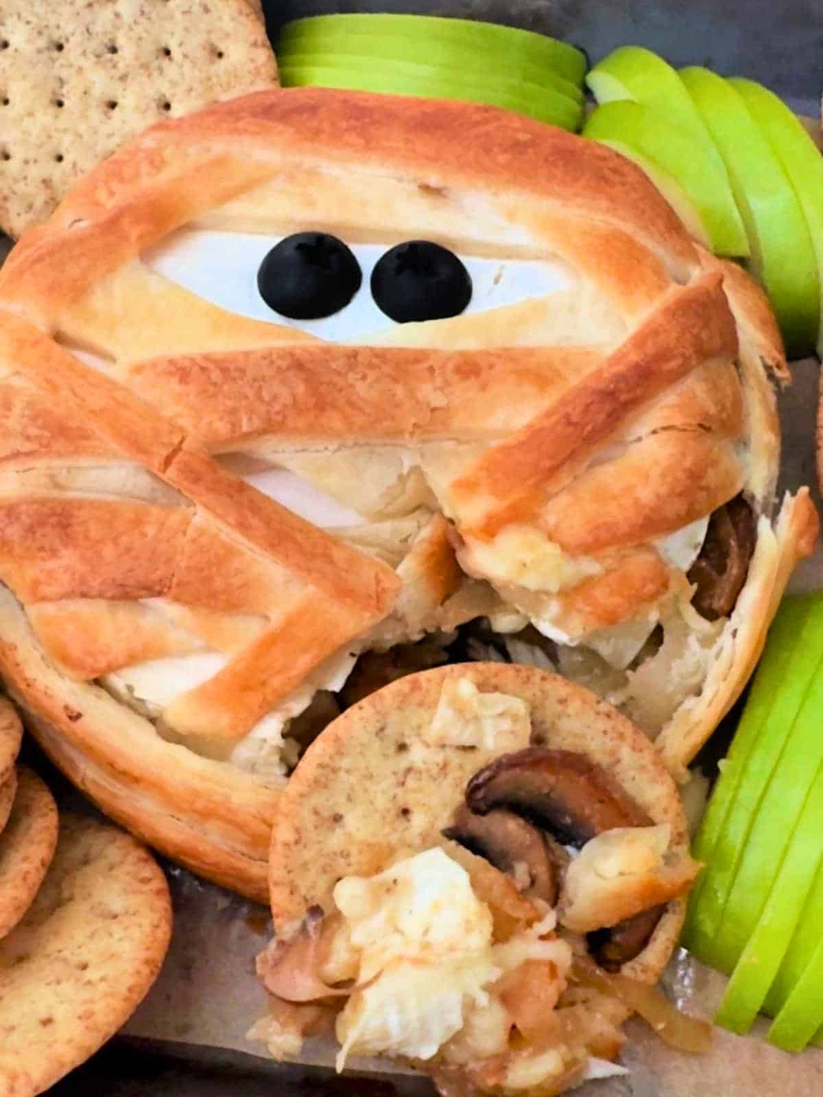 serving of mummy brie served on top of a cracker