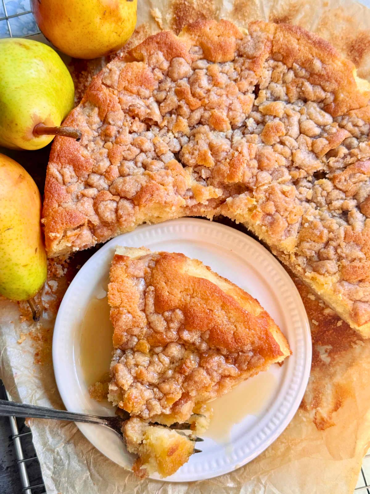 plated slice of pear cake with a bite taken