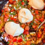 taco dip garnished and ready to serve from the crockpot